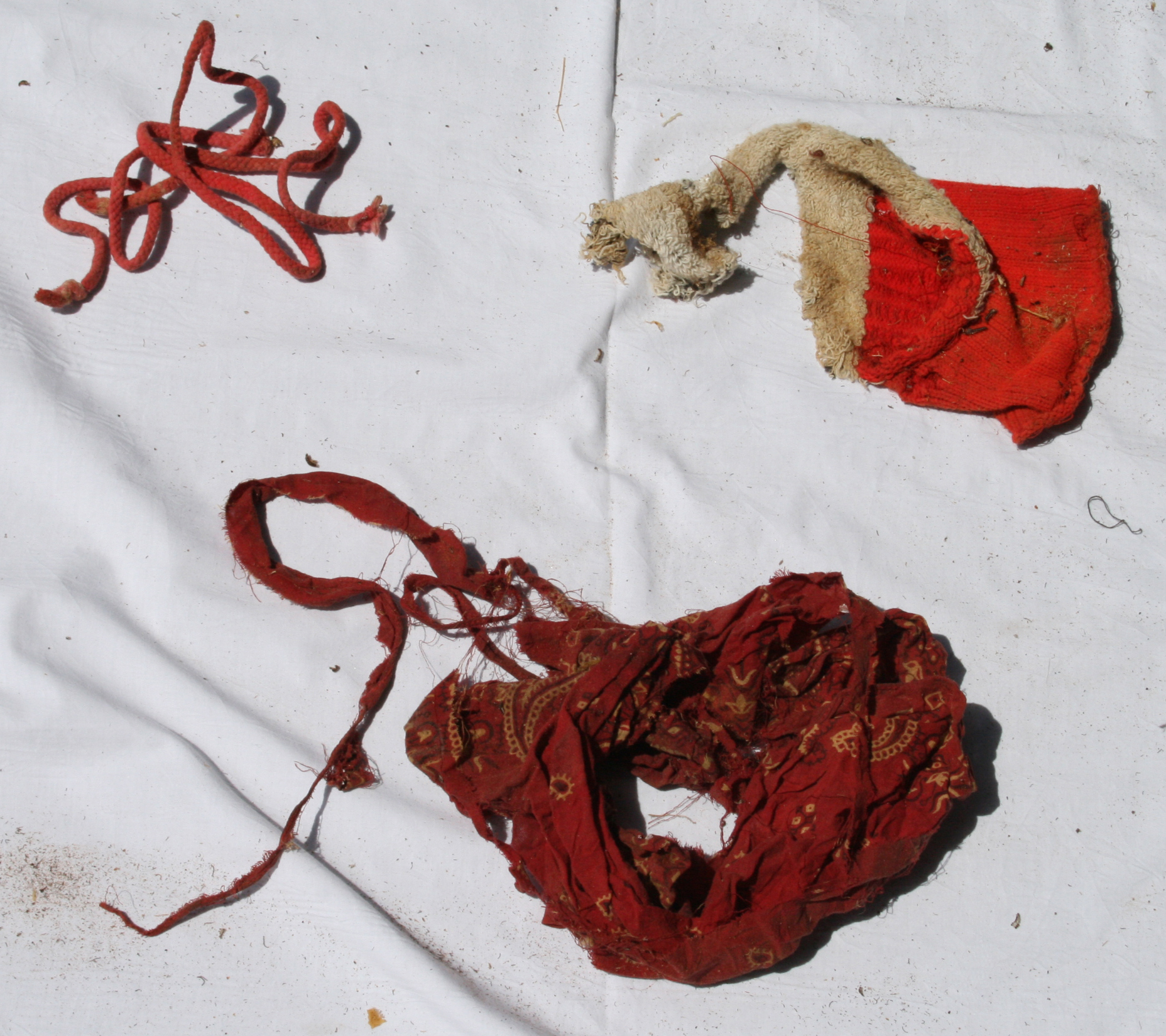 NamUs UP10065 — red bandana, red cord, and white and red sock