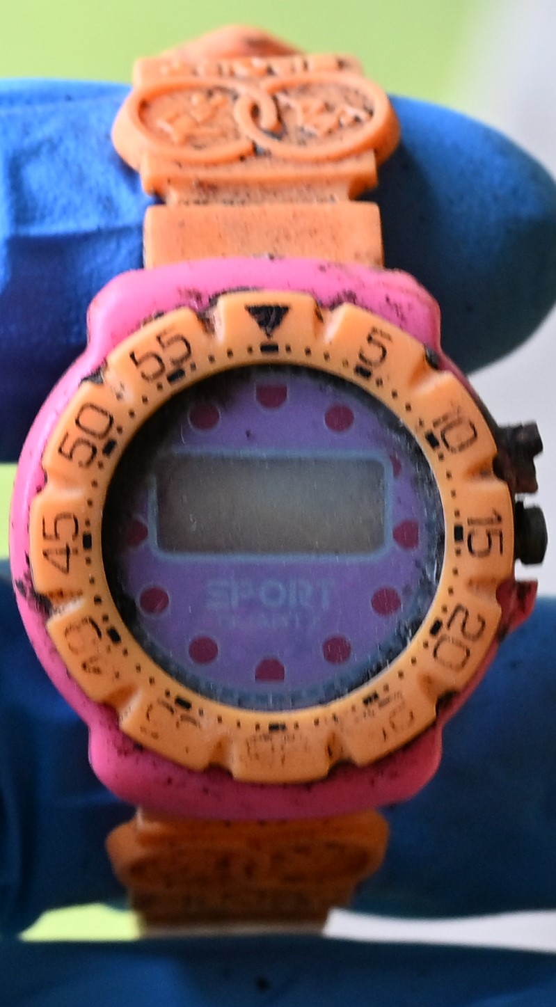 NamUs UP1012 — Digital sports-type wristwatch with a small face, plastic band that is orange, pink & yellow